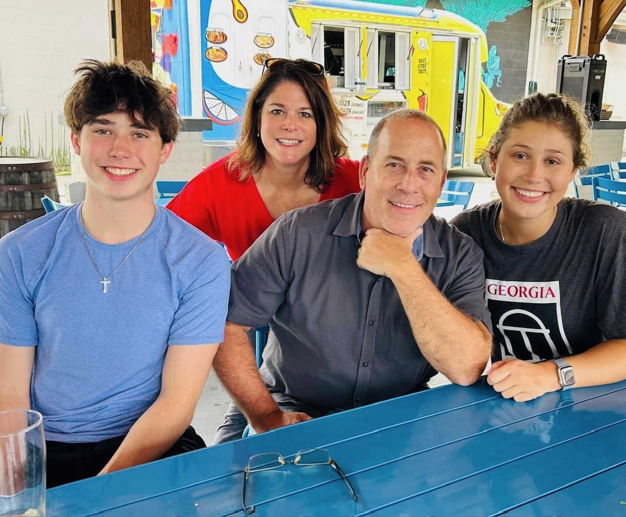 Father with family at outdoor table