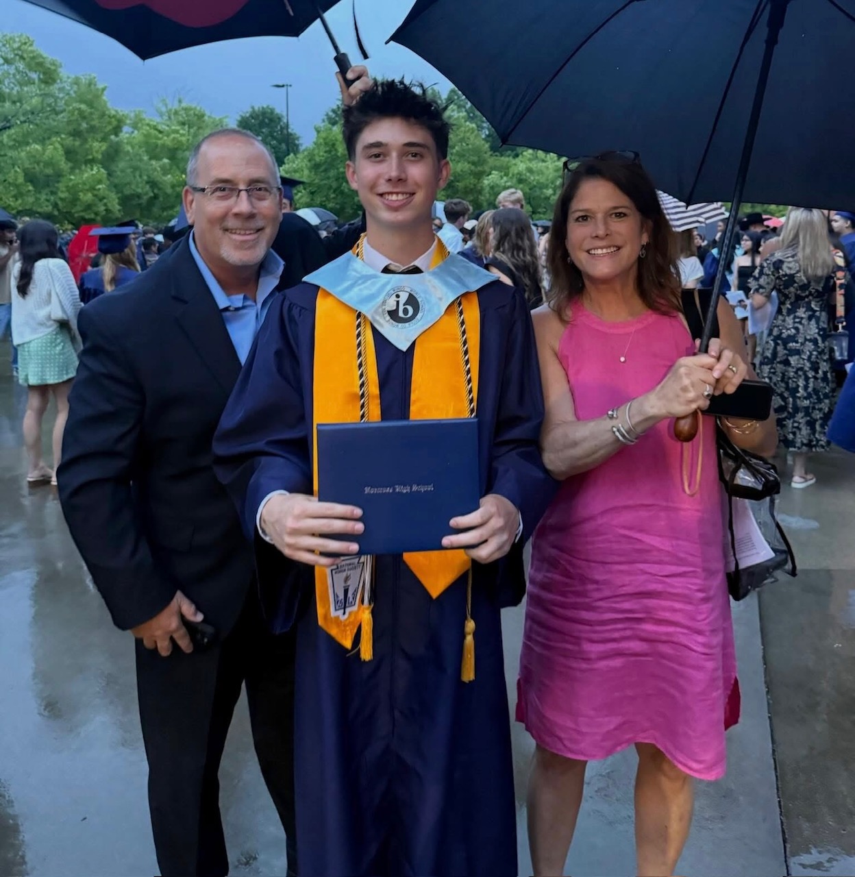 Father and mother with son at graduation